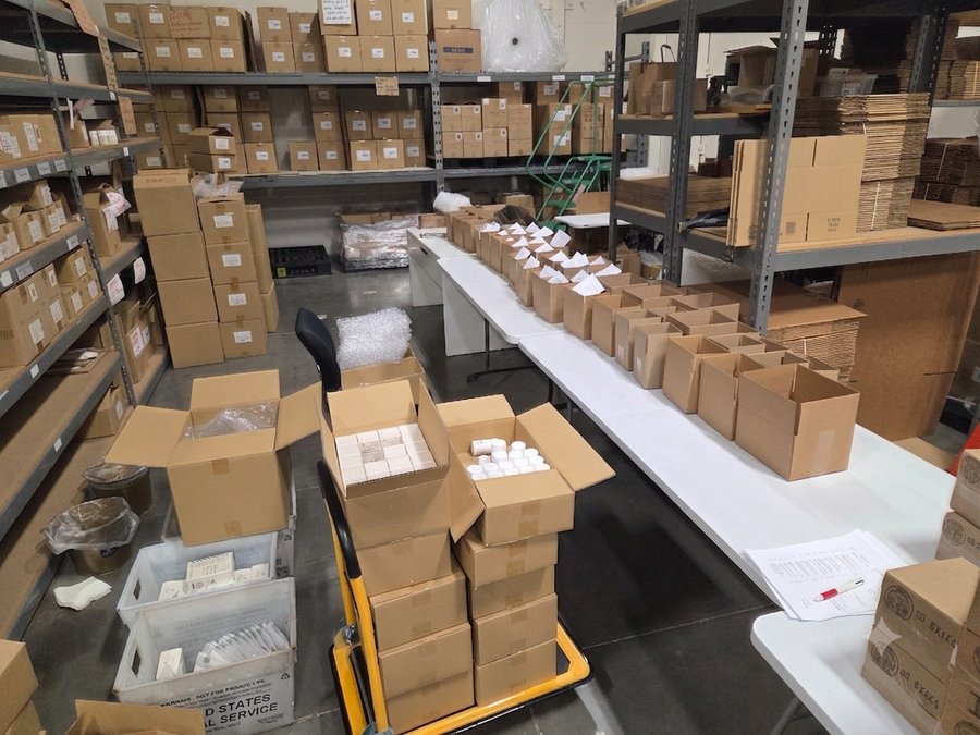 Warehouse packing room with stocked shelving and staged orders